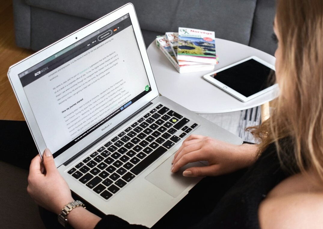 person writing blog on laptop
