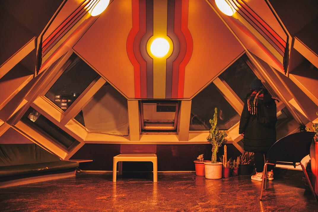 Wide interior shot of a modern podcast recording studio with acoustic panels
